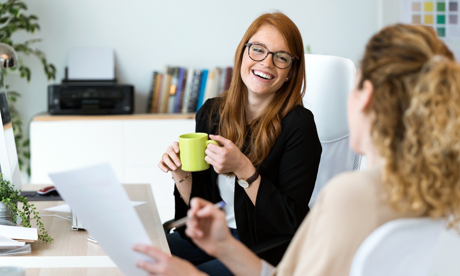 Zwei Frauen bei der Karriereberatung unterhalten sich über die Potentialanalyse und freuen sich